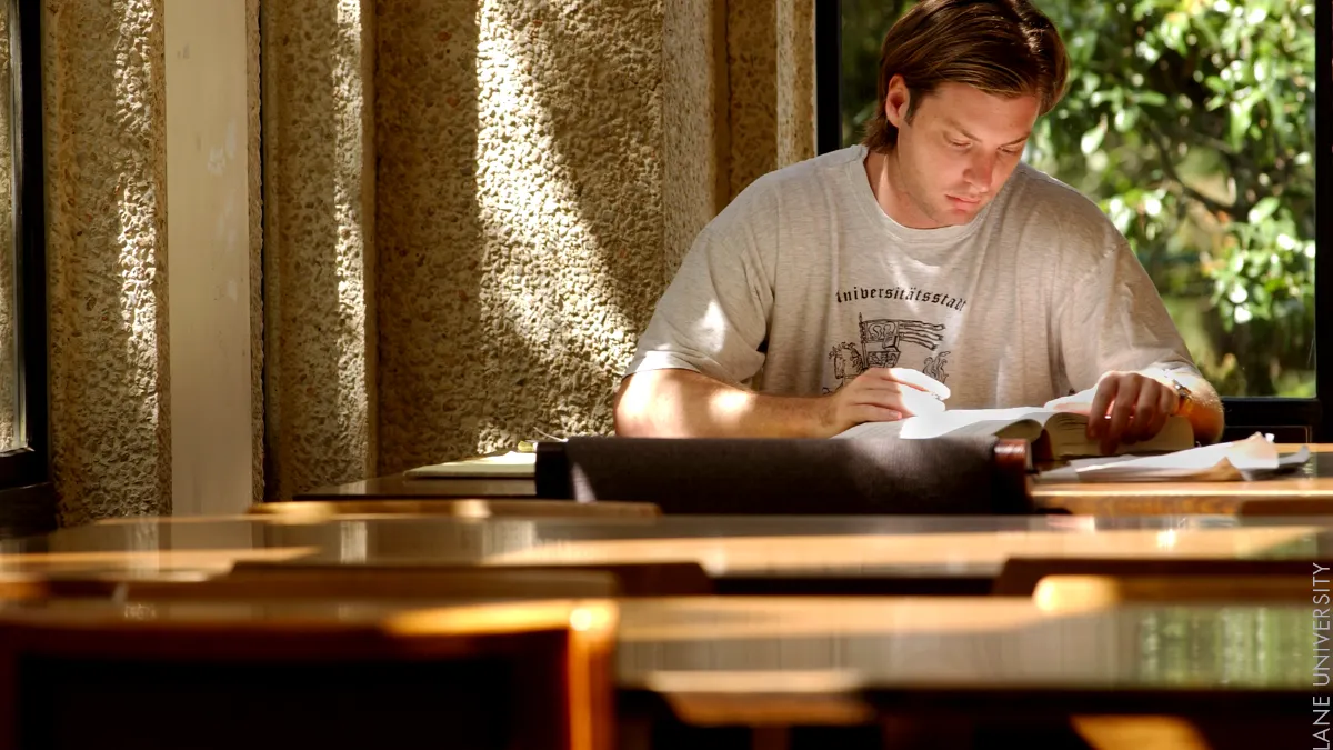 Student reading in a university library